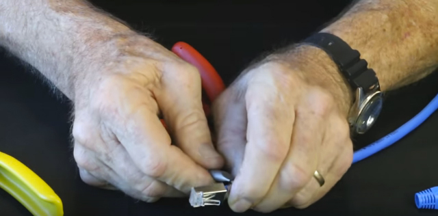 Put drain wire coil and foil if present under external ground tab, press tabs down with flat blade screwdriver or similar to hold in plac