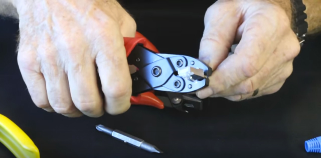 Crimp external ground tab to cable, rotating large then small cavities of crimp tool